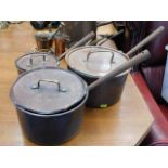 Three Victorian copper saucepans with lids