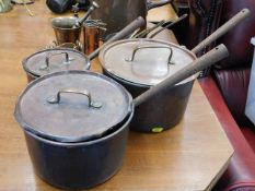 Three Victorian copper saucepans with lids