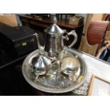 A small three piece silver plated service with tra