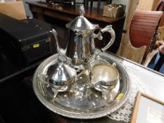 A small three piece silver plated service with tra