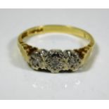 An 18ct gold ring with three small platinum mounte