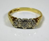 An 18ct gold ring with three small platinum mounte