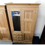 A solid light pine wardrobe with three drawers & a