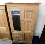 A solid light pine wardrobe with three drawers & a