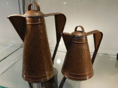 Two hand made copper jugs with lids by Pippa Long,