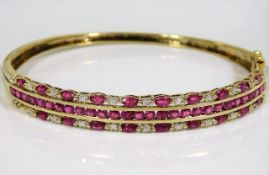 A 9ct gold bangle profusely set with diamond & rub