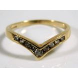 A 9ct gold wishbone ring set with diamonds 2.1g