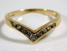 A 9ct gold wishbone ring set with diamonds 2.1g