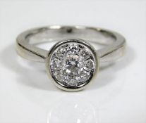 An 18ct white gold daisy ring set with eight diamo