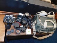 A quantity of vintage camera equipment & lenses in