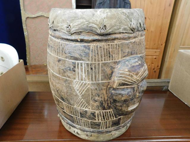 An antique African carved wood drum with carved ma