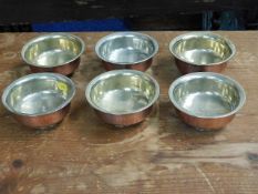 Six Tibetan white metal lined copper dishes
