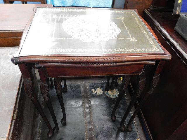 A nest of three tables with glass tops