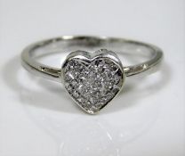 An 18ct white gold ring with a diamond filled hear