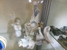 A Lladro figurine, 9.5in tall & three other pieces