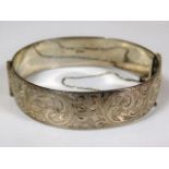 A chased silver bangle 48.4g