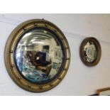 An antique convexed mirror & one other