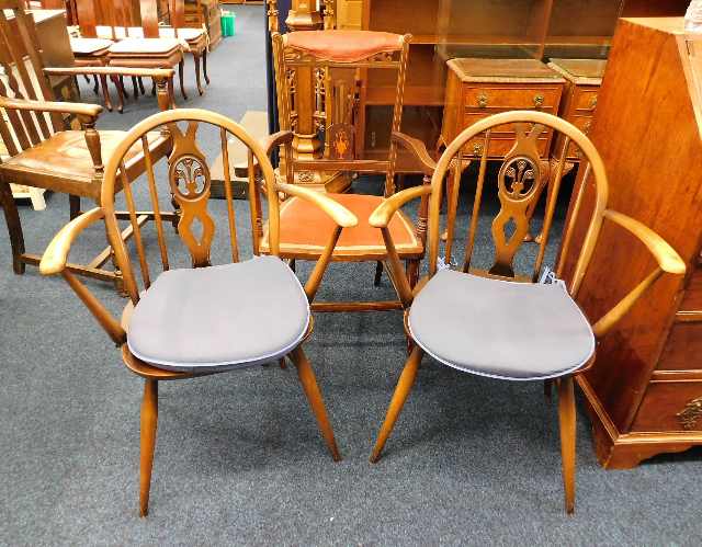 A pair of mid 20thC. Ercol carvers twinned with an