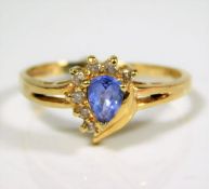 A yellow metal ring set with diamonds & cornflower