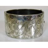 An engraved silver bangle