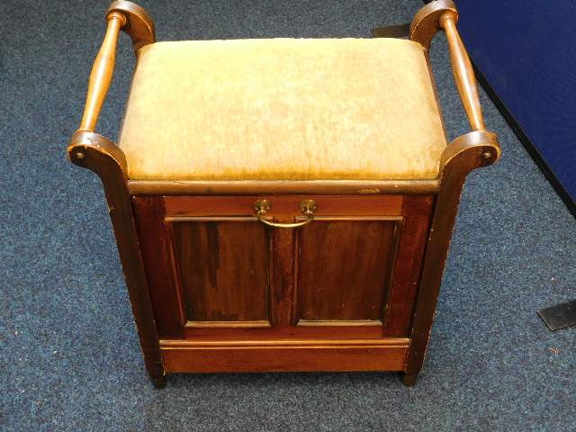 An Edwardian music stool with pull down store