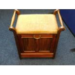 An Edwardian music stool with pull down store