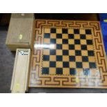 A modern chess board with chess pieces & a dominoe