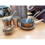 A copper & brass handled five pan set twinned with