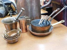 A copper & brass handled five pan set twinned with
