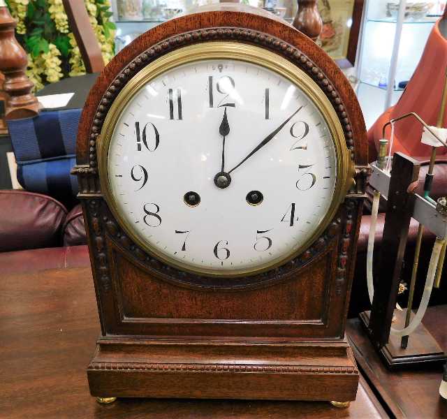 An antique dome cased mantle clock