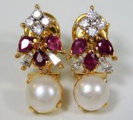 A pair of 18ct gold earrings set with Burma ruby,