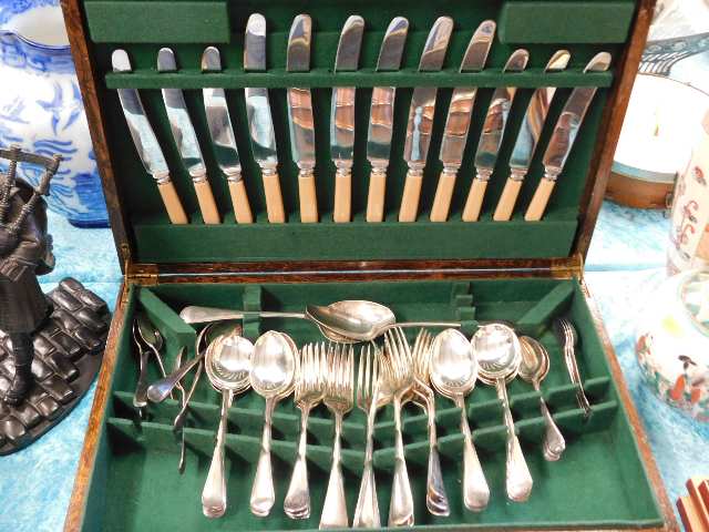 A cased cutlery set including silver plated spoons