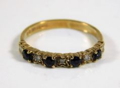 A 9ct gold half eternity ring set with diamond & s