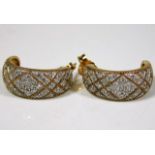 A pair of 9ct gold half hoop earrings set with dia