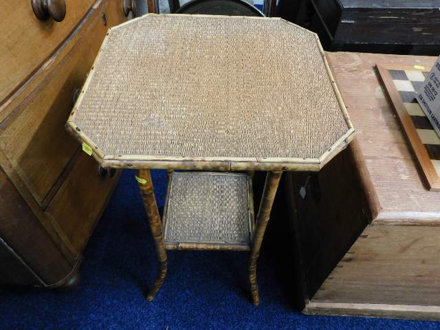 A 20thC. cane two tiered table
