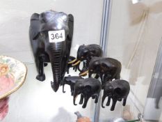 A small collection of carved hardwood elephants