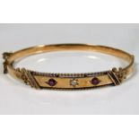 A 15ct gold bangle set with diamond & ruby, inscri