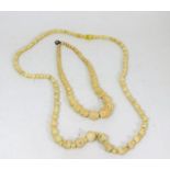 A carved ivory & bone necklace twinned with a smal