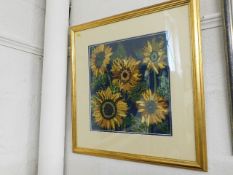 A framed embroidered picture of sunflowers