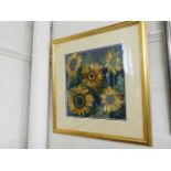 A framed embroidered picture of sunflowers