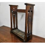 An art nouveau oak stick stand with trays, some faults
