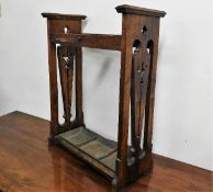 An art nouveau oak stick stand with trays, some faults