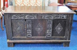 An 18thC. oak coffer with carved frieze & panels