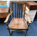An oak arm chair with leather seat