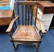 An oak arm chair with leather seat