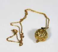 A 9ct gold chain with yellow metal sphere shaped p