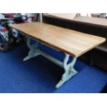 An oak farmhouse style trestle table with stained