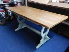 An oak farmhouse style trestle table with stained