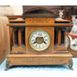 A wooden mantle clock twinned with two others of w