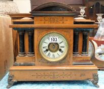 A wooden mantle clock twinned with two others of w